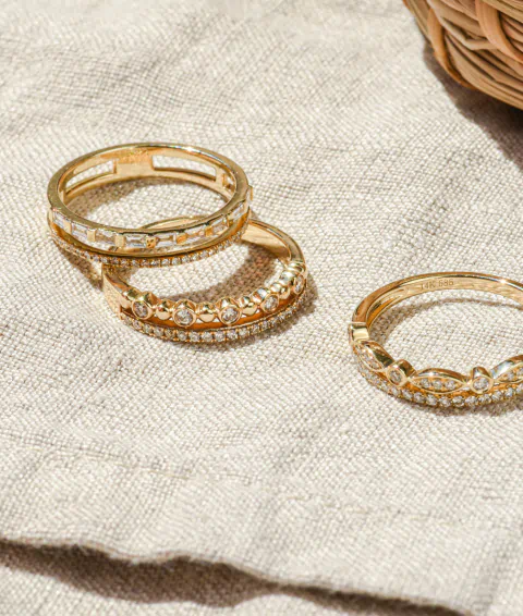 Gold rings on a table covered in fabric