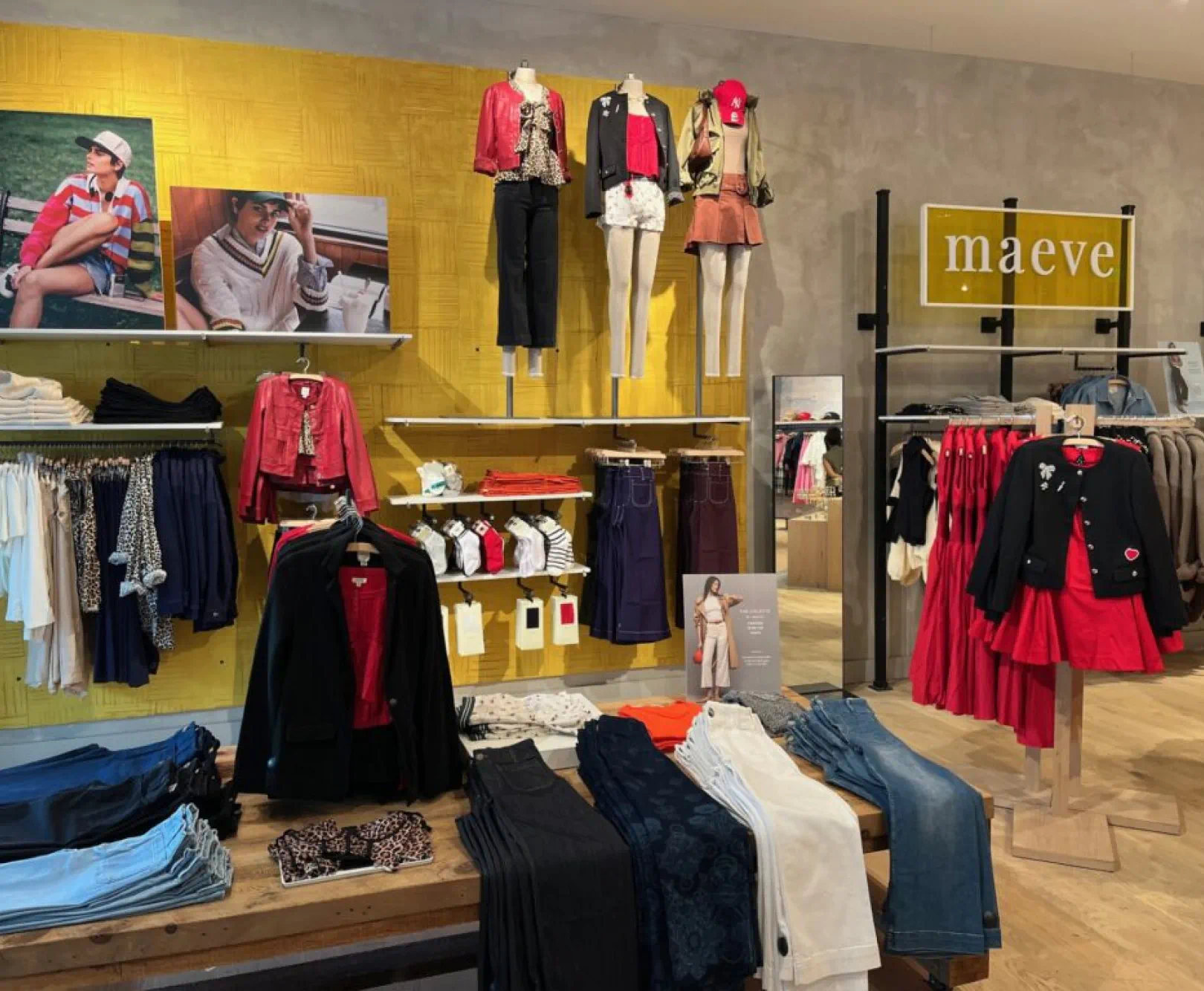 The many clothes of Anthropologie sit on racks. There are jeans, dresses, socks, and more.