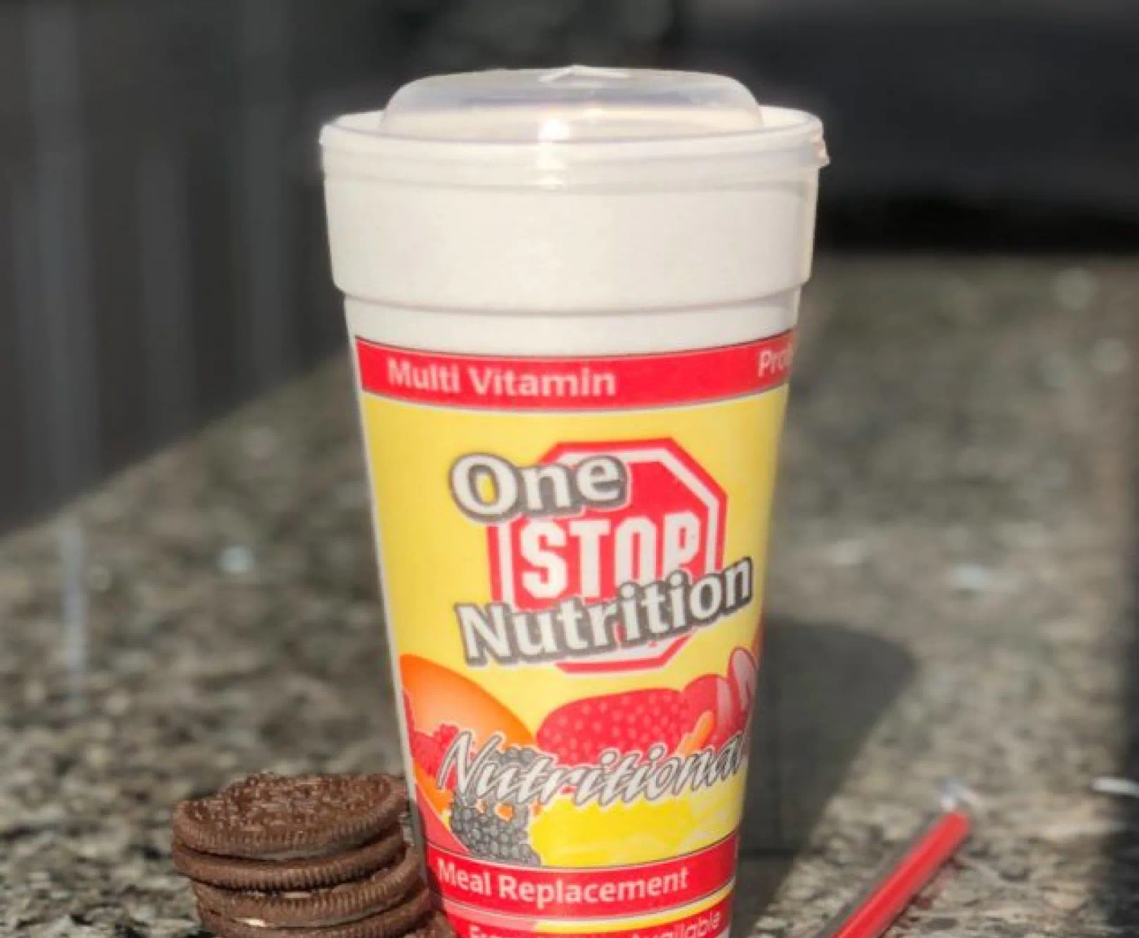 A protein shake is served with cookies.