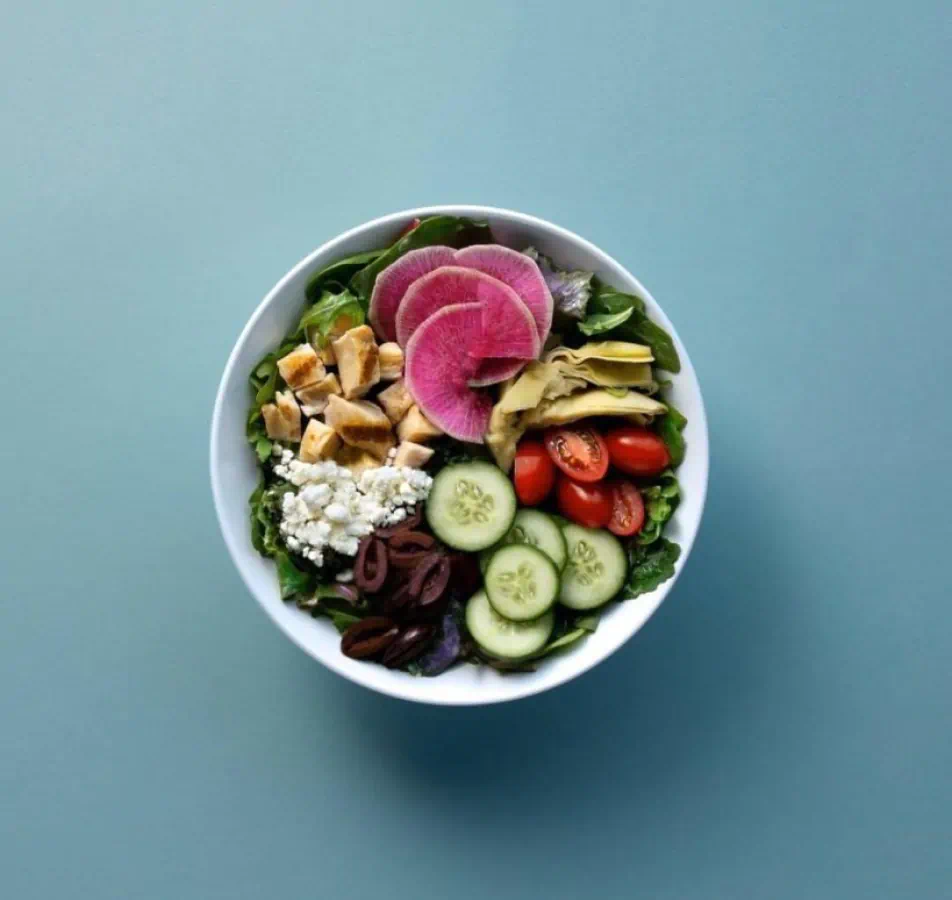 Colorful Salad sitting on blue background