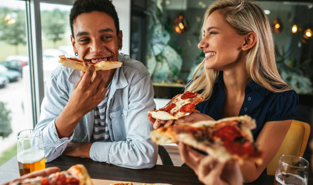 Friends eating pizza together