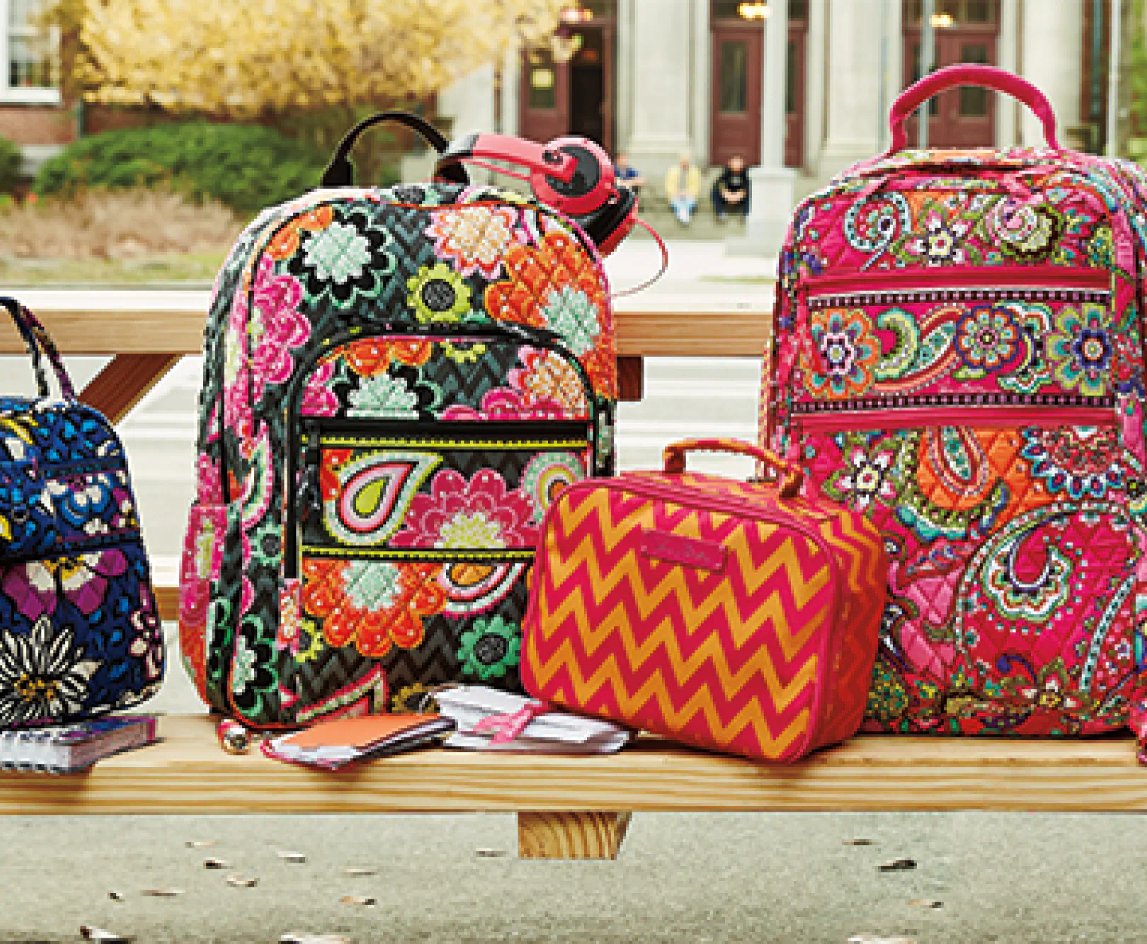 vibrant, floral patterned backpacks sitting on a picnic table