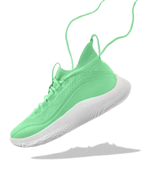 A green running shoe suspended in air with a white sole and loose laces.