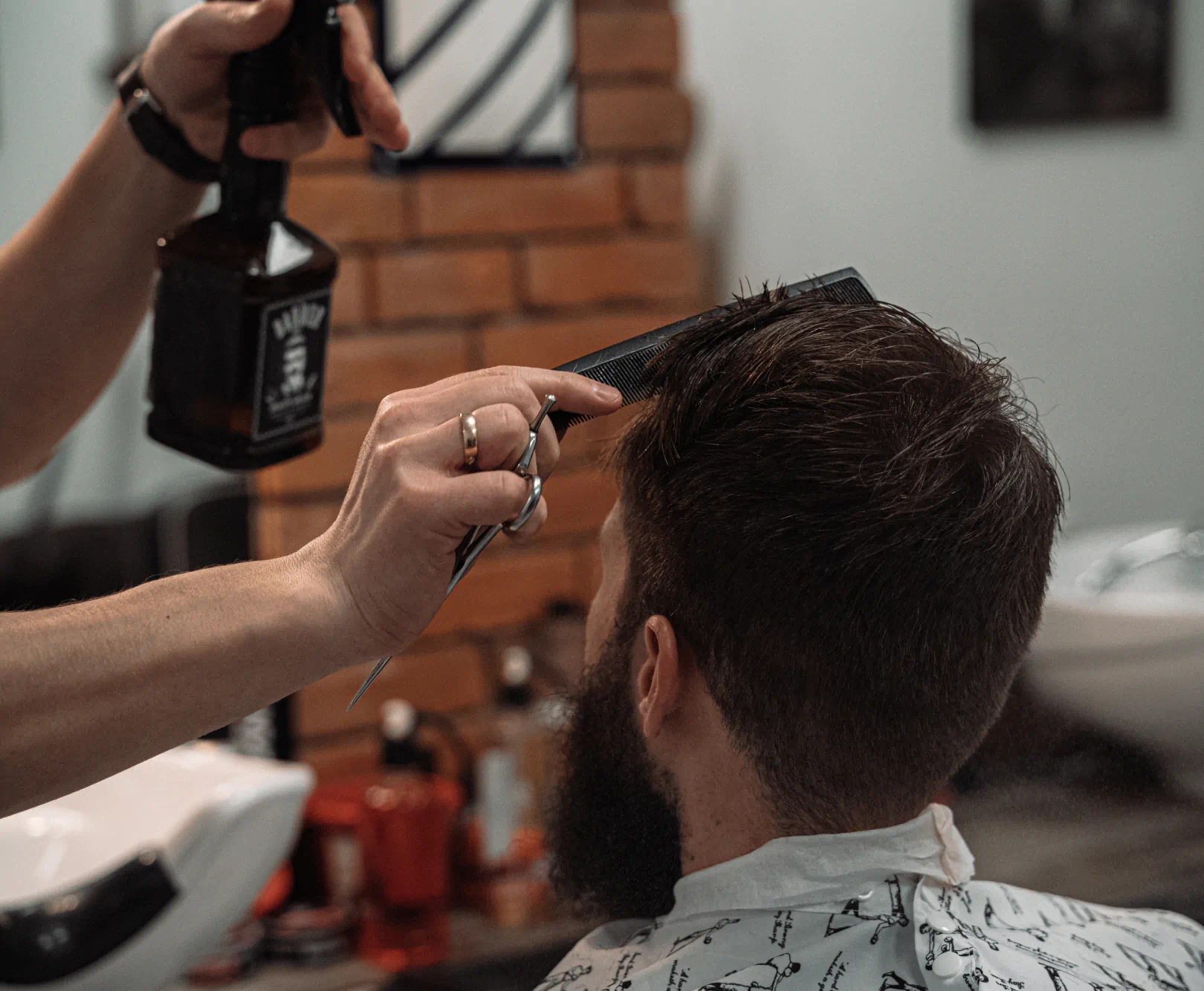 Man getting a haircut with a comb running through his hair