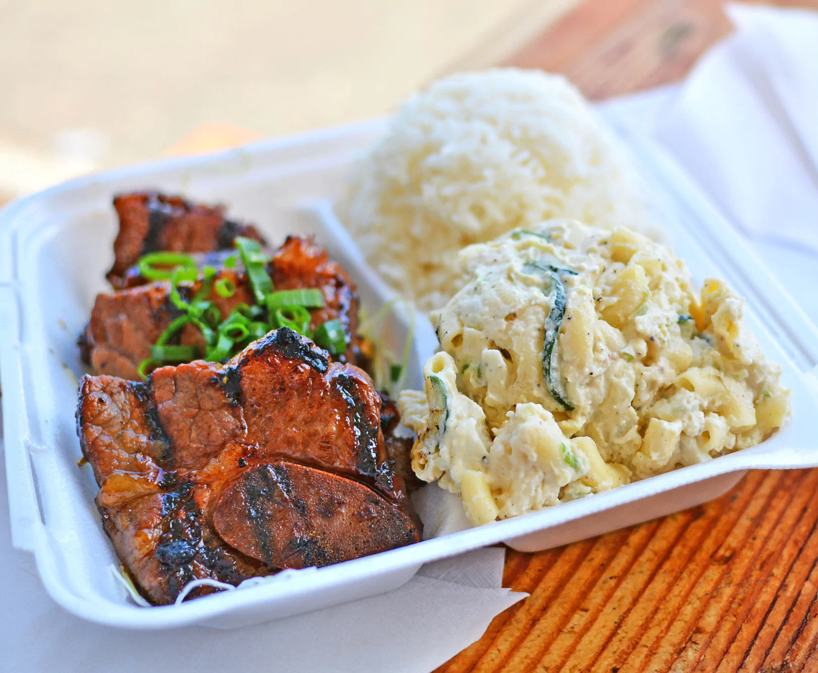 To-go container with meat and sides