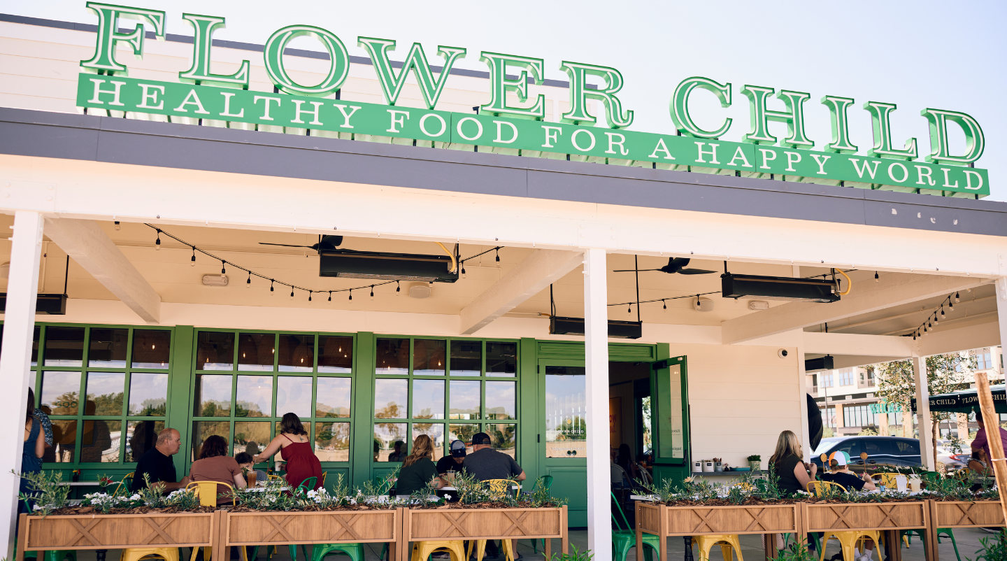 Flower Child outdoor patio. People are sitting and enjoying lunch.