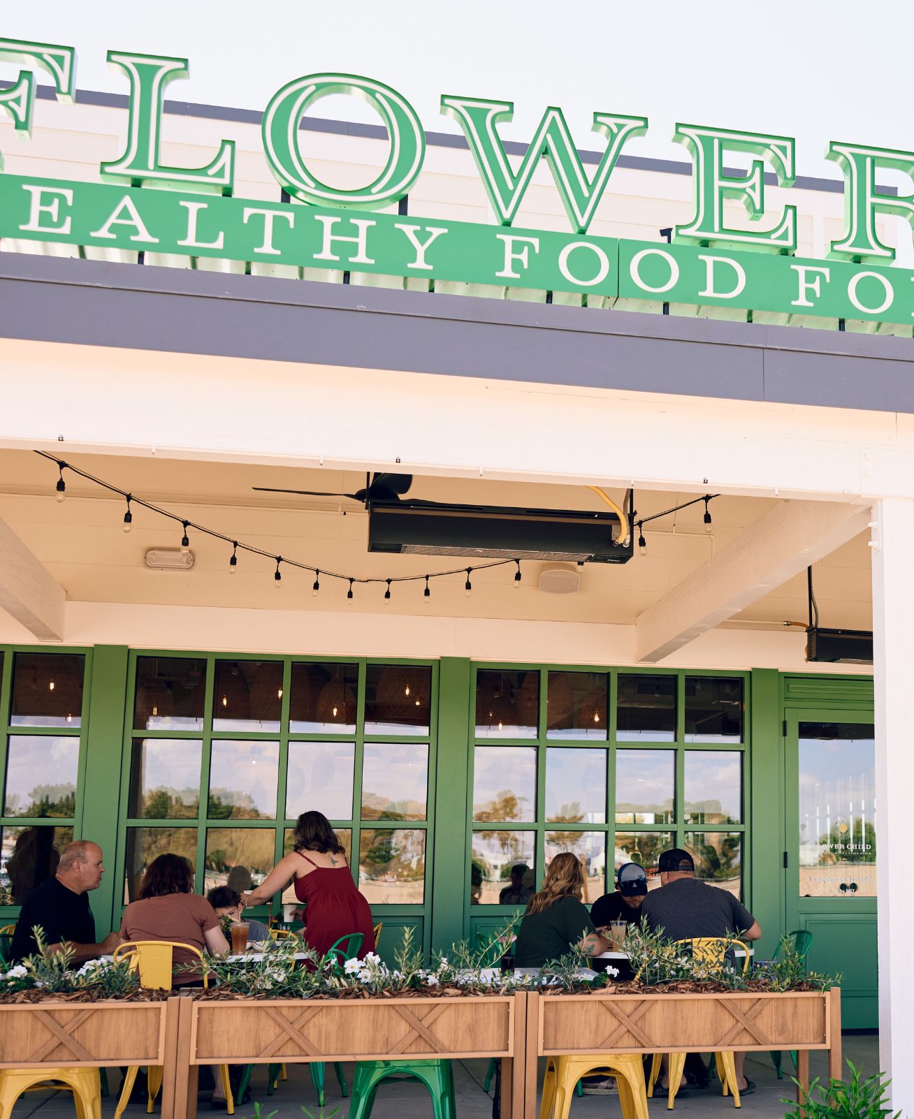Flower Child outdoor patio. People are sitting and enjoying lunch.