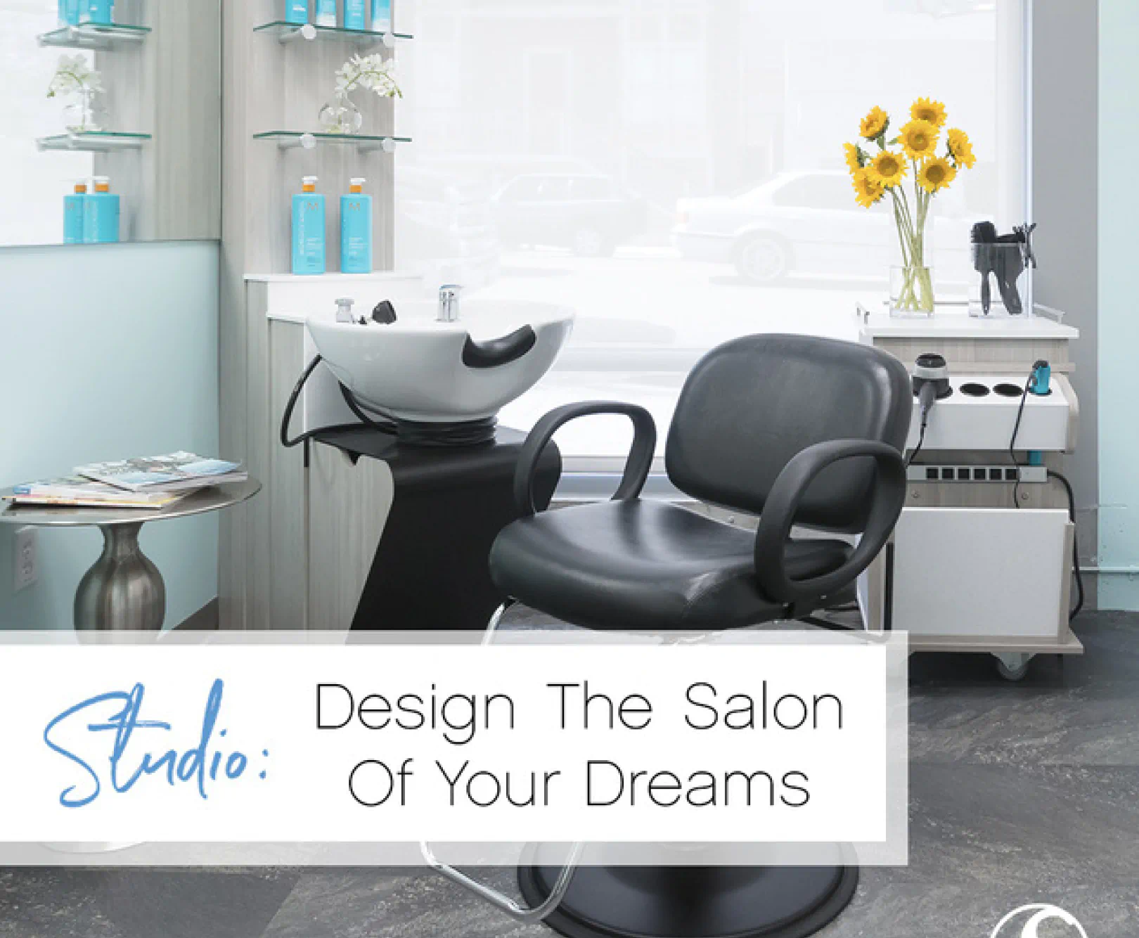 Modern hair salon interior with a black chair, white sink, and trolley holding yellow sunflowers.