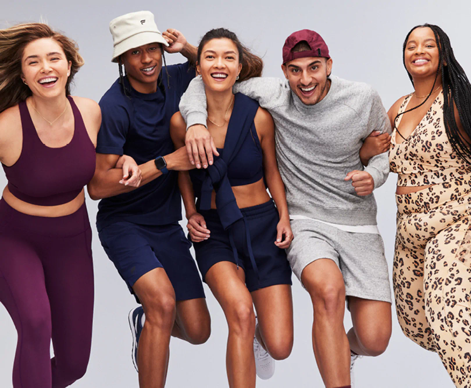 A group of young people show off their athletic wear while running in place.